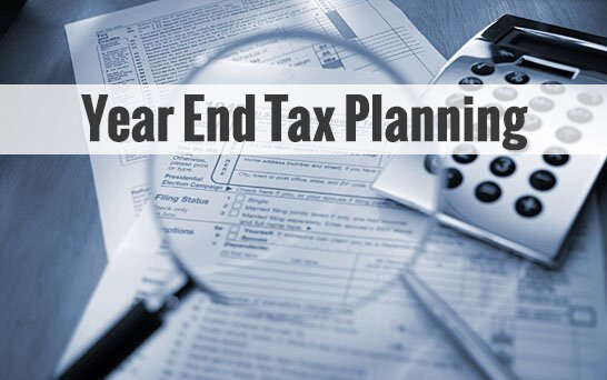 Year end tax planning with magnifying glass